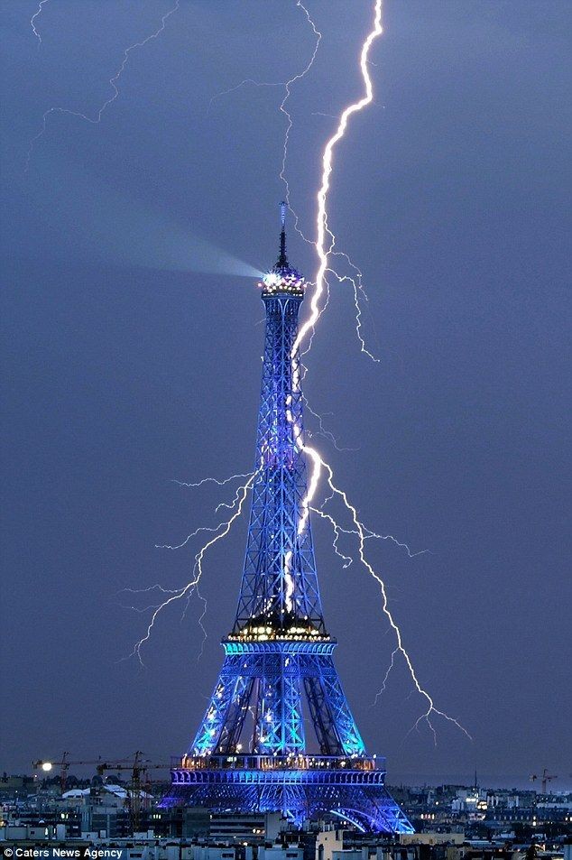"Electrifying: The Eiffel Tower glows blue as it i...