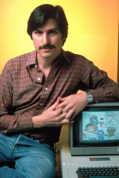 Apple co-founder Steve Jobs posing w. Apple II com...