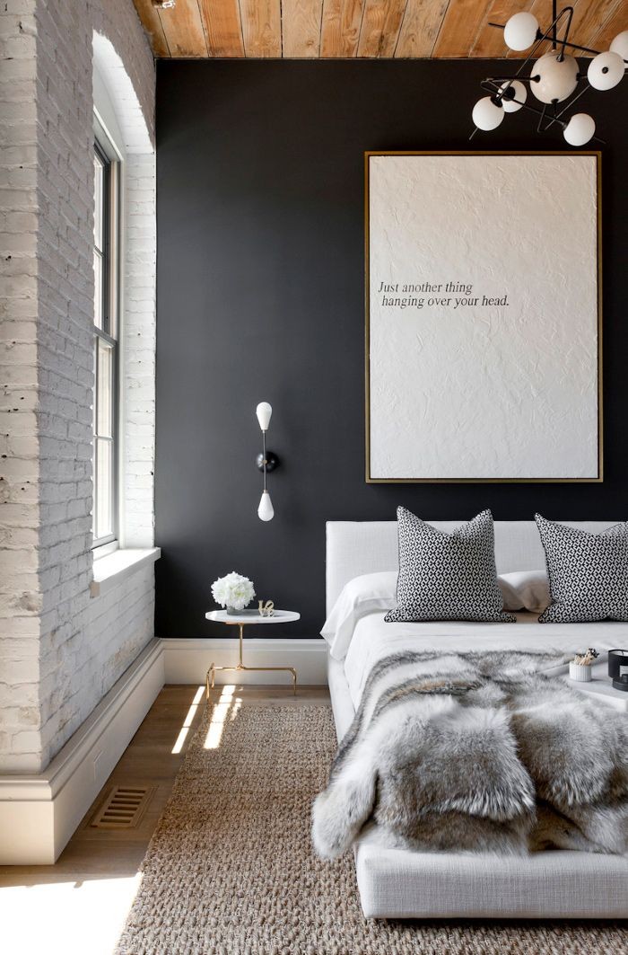 bedroom with black wall and wooden ceiling