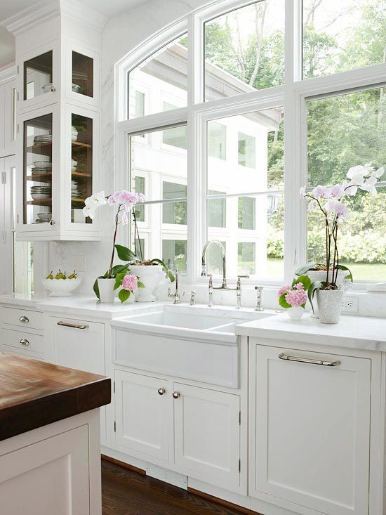 Stunning kitchen design with arched window, creamy...