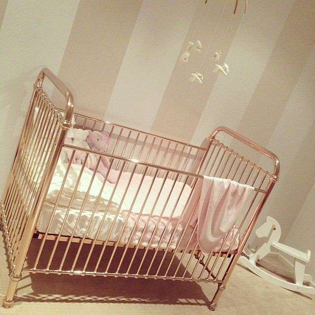 Rose gold metal cots for the girls.
