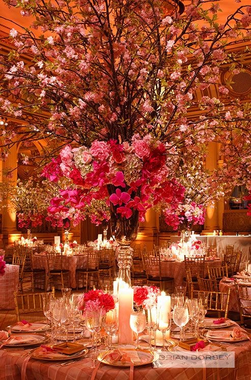 A grand wedding centerpiece of orchids and romanti...