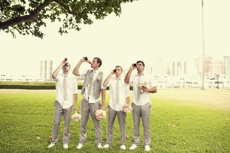 The groomsmen holding the bridesmaid bouquets