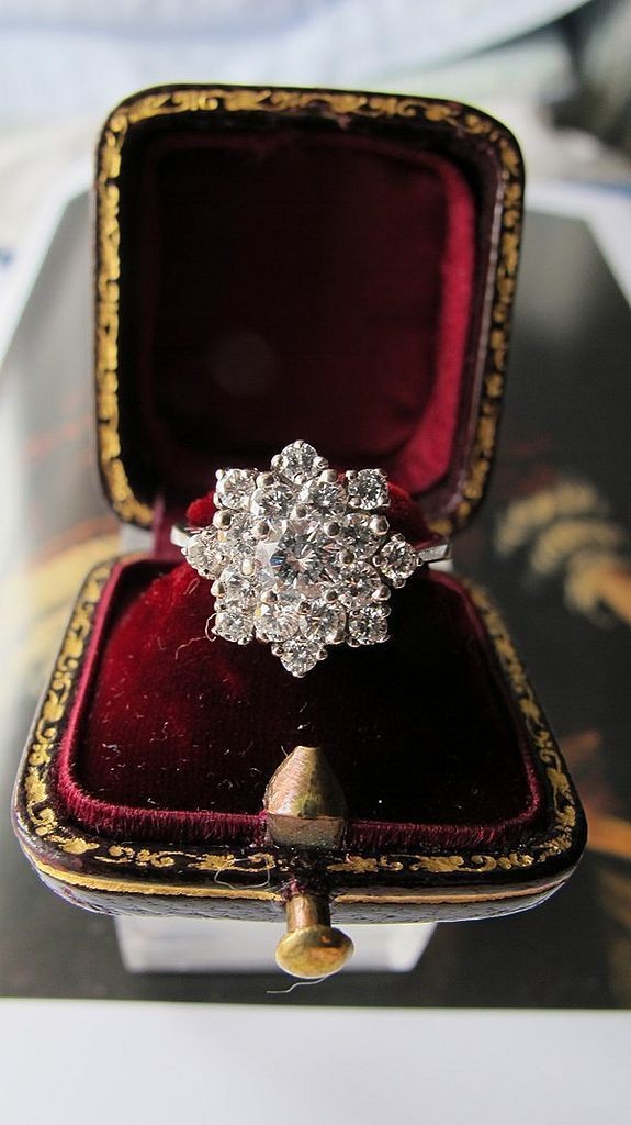 A diamond ring designed as a cluster, set in a 14...