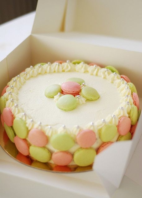 French macaroons surrounding a cake. Can it get be...