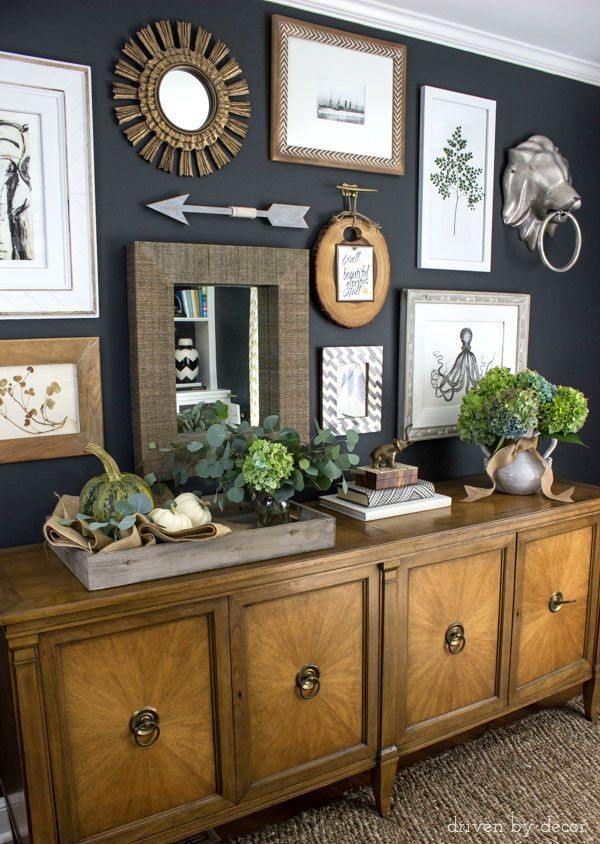 Eclectic gallery wall on dark charcoal walls | con...