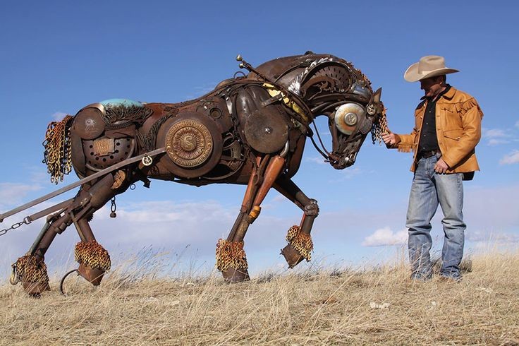 Old cast off farm equipment recycled into works of...