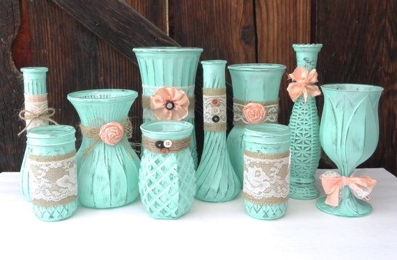 A group of 10 glass vases, jars and/or bottles are...
