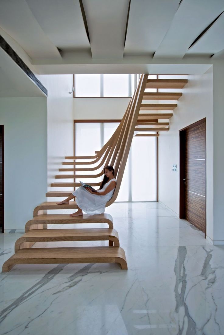 Sculptural Staircase Defines A Modern Two-Storey A...