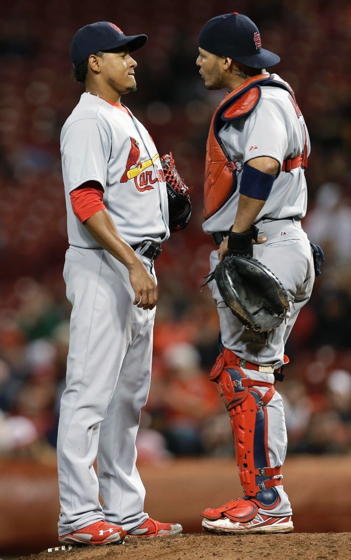 relief pitcher Carlos Martinez talks with catcher...