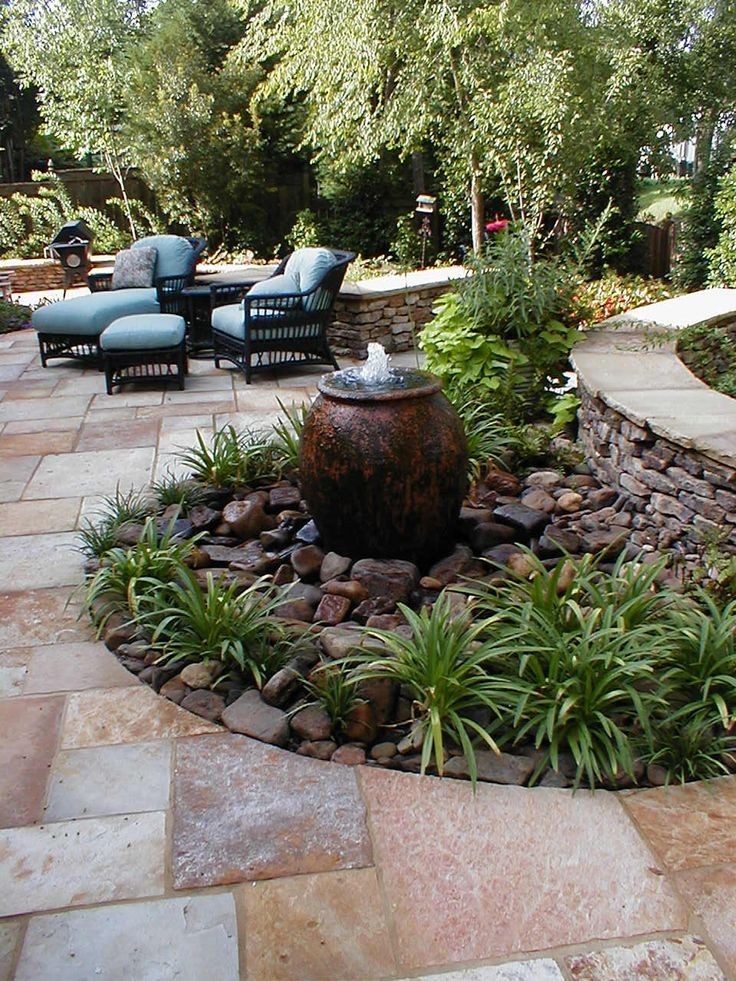 Fountain in landscaping. By Madison Planting and D...