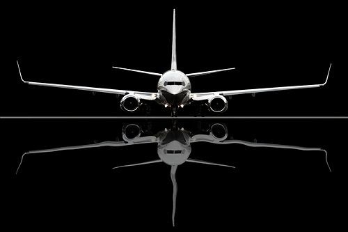737 Boeing Business Jet BBJ, reflecting in a puddl...