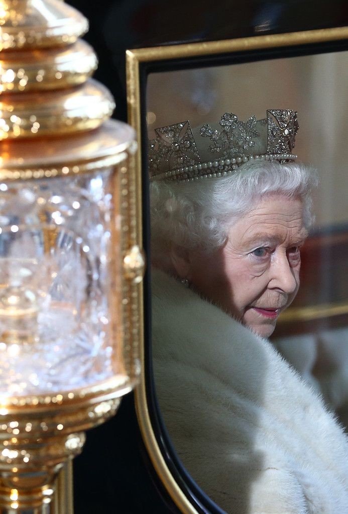 Britain's Queen Elizabeth II looks out from her ca...