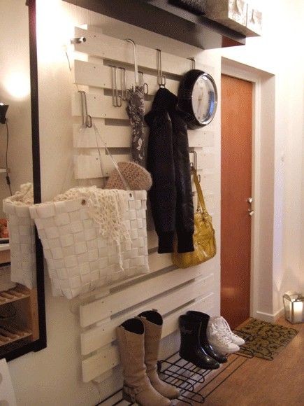 Paint a pallet white and hang stuff from it with o...