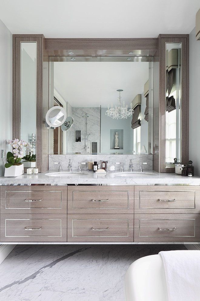 Floating gray washed wood vanity with metallic tri...