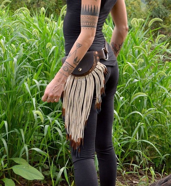 arm tattoos and leather pouch belt