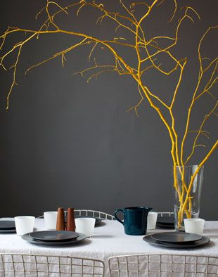 Find branches and spray paint them a bold theme co...