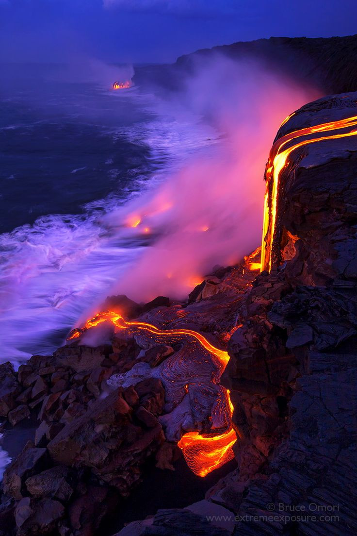 Molten lava cascades over a 30 foot cliff, creatin...